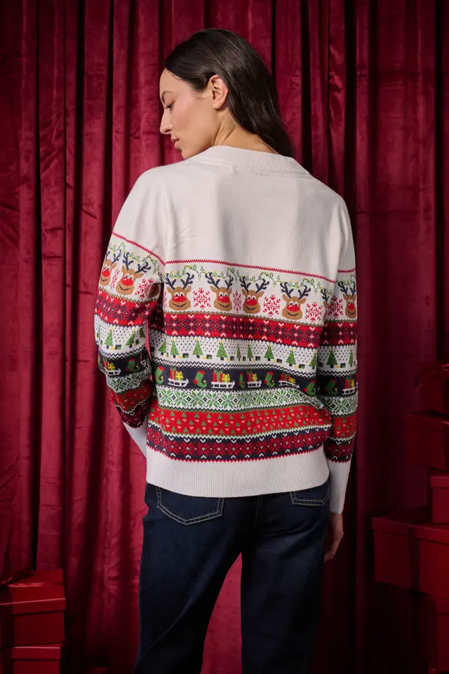 Woman in a fair isle Christmas sweater with dark jeans