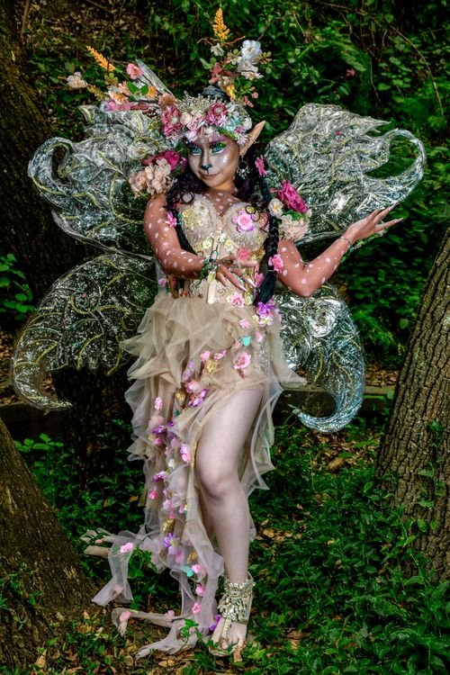 Woman dressed as a garden fairy Halloween costume with wings