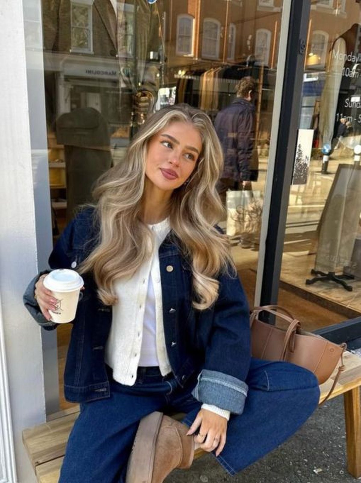 Woman in denim-on-denim with team accessories for fall game day