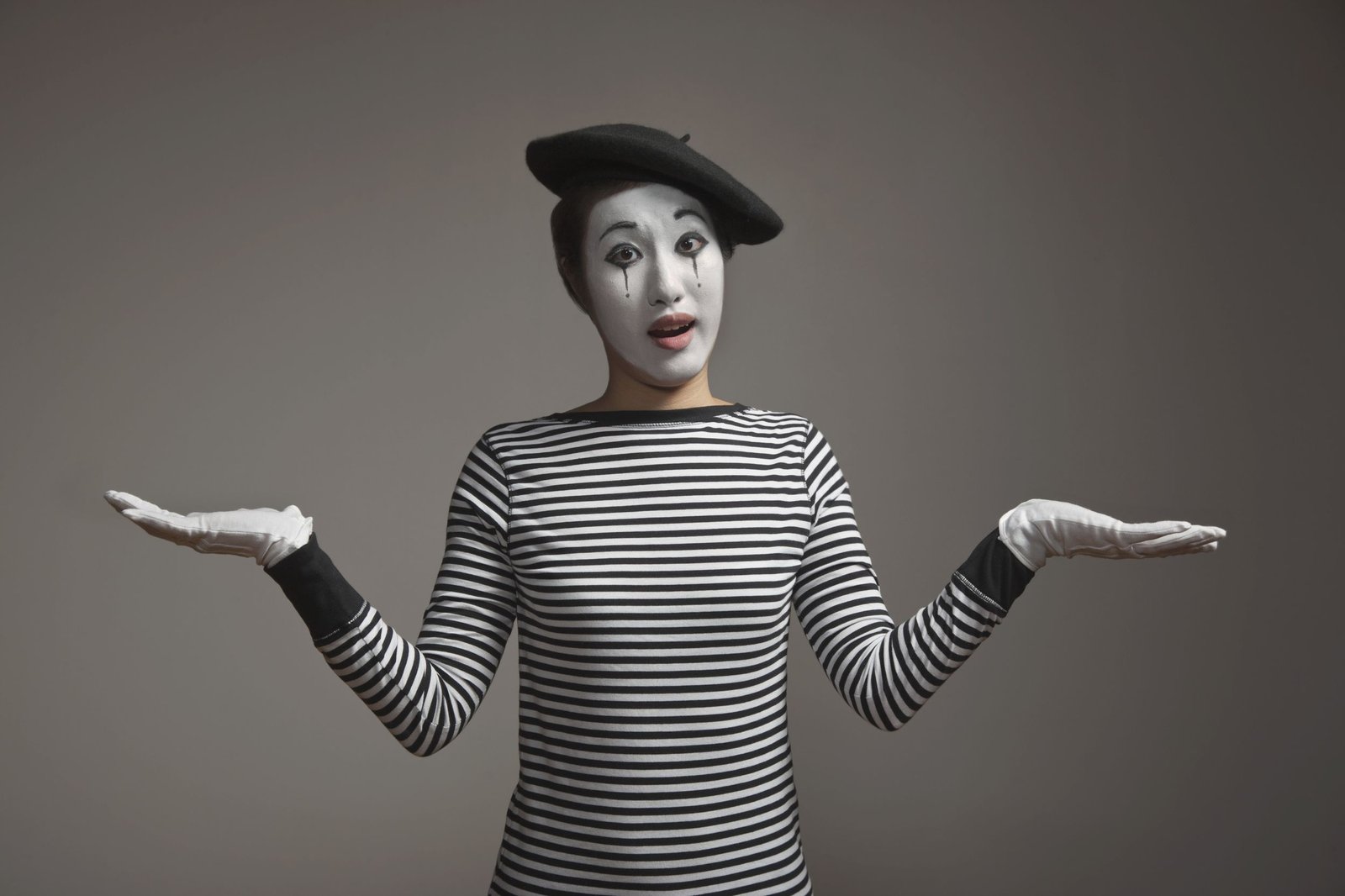 Woman dressed as a silent mime Halloween costume with striped shirt