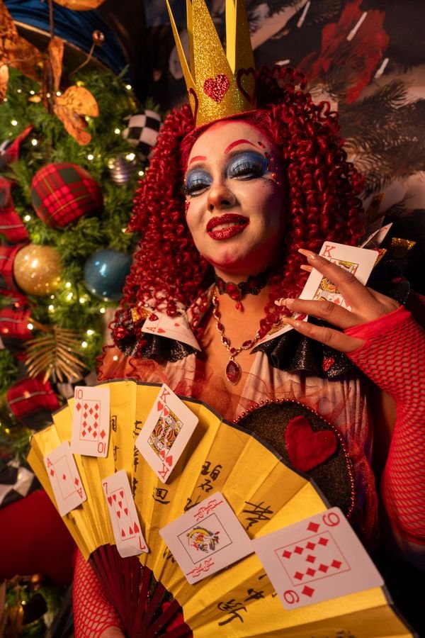 Woman dressed as the Queen of Hearts Halloween costume with crown