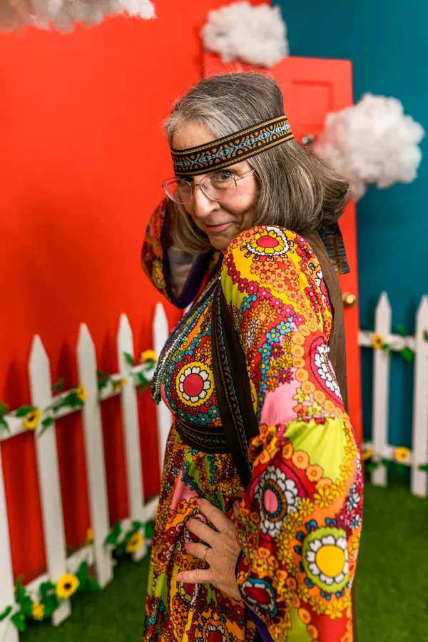 Woman dressed as a 70s hippie Halloween costume with flower crown