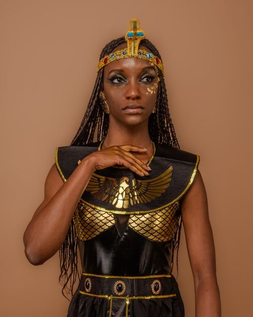 Woman in a Cleopatra Halloween costume with gold jewelry