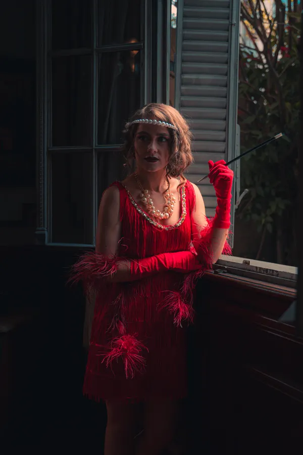 Woman in a 1920s flapper girl Halloween costume with fringe dress
