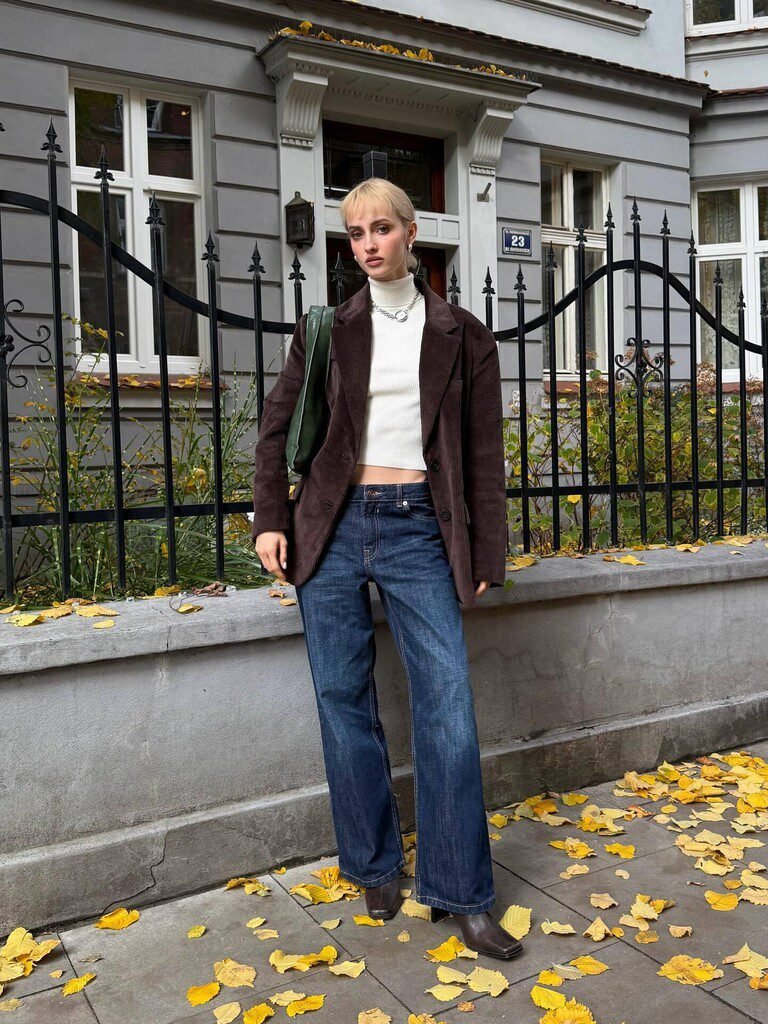 Woman wearing an oversized corduroy blazer over straight-leg jeans
