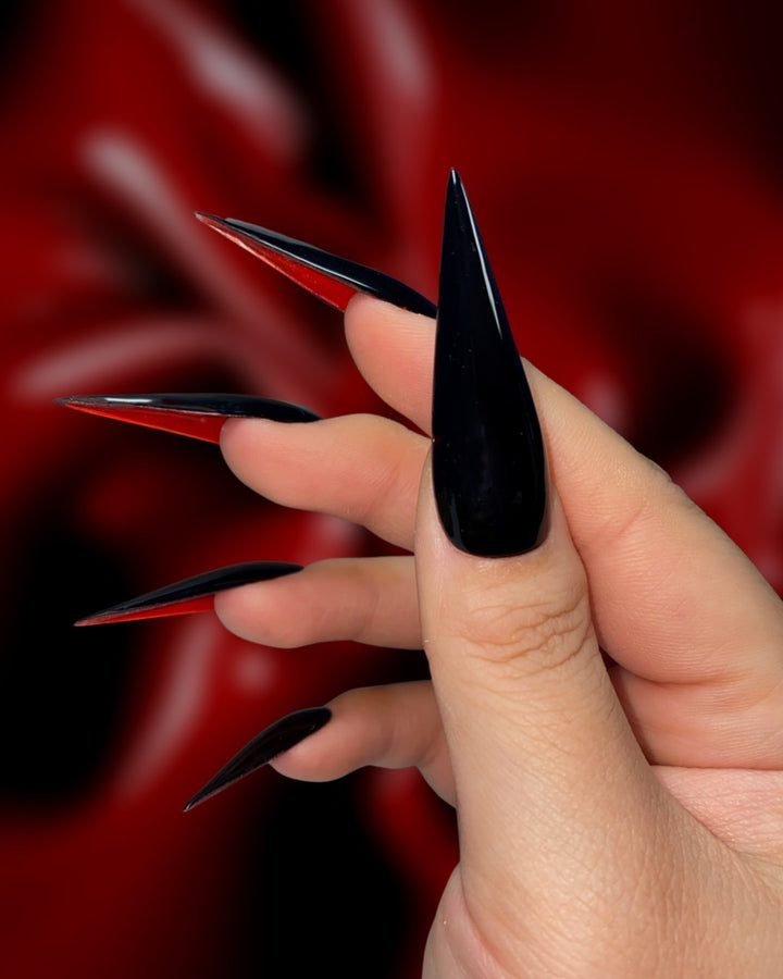 Black stiletto nails with red undersides like red bottom heels