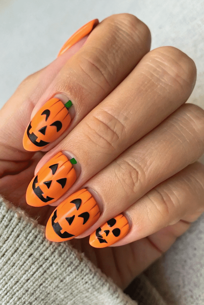 Long nails with jack o lantern pumpkin face nail art