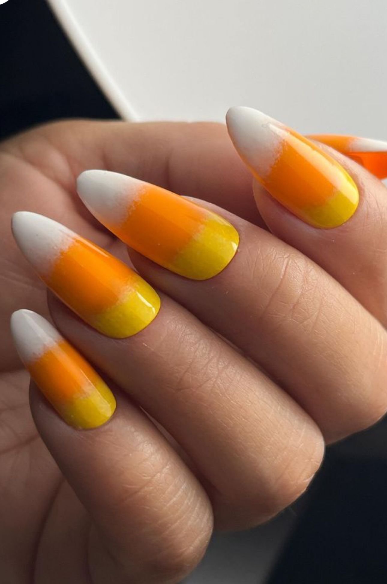 Long nails with candy corn french tip halloween design