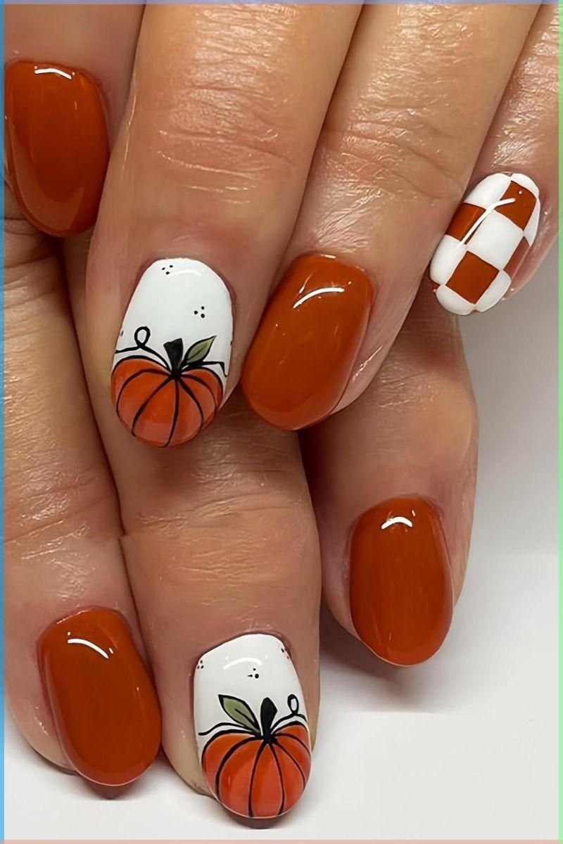 Burnt orange fall nails with a single pumpkin accent nail