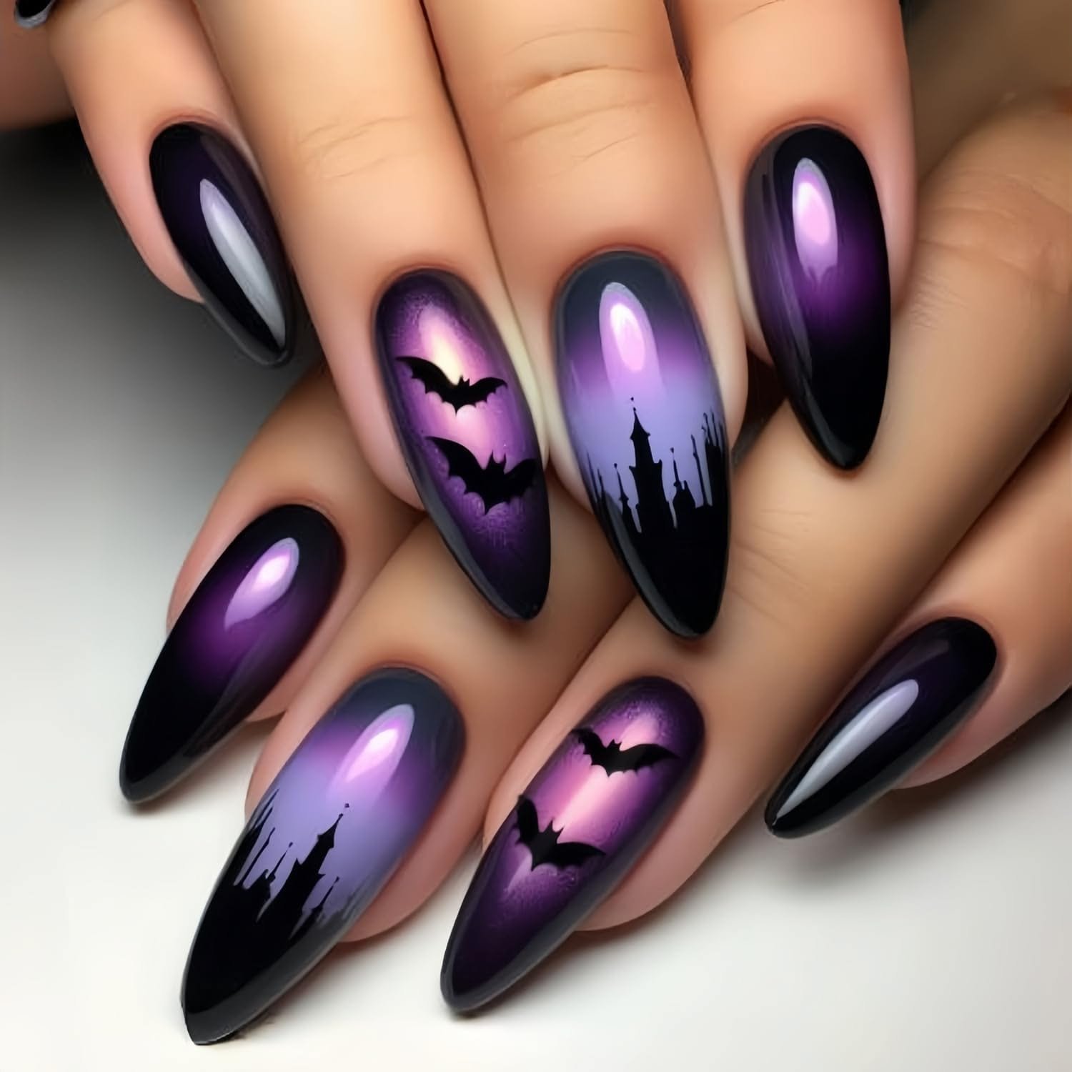 Purple ombre Halloween nails with a bat silhouette accent nail