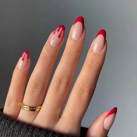 Sheer pink Halloween nails with a bloody French tip accent nail