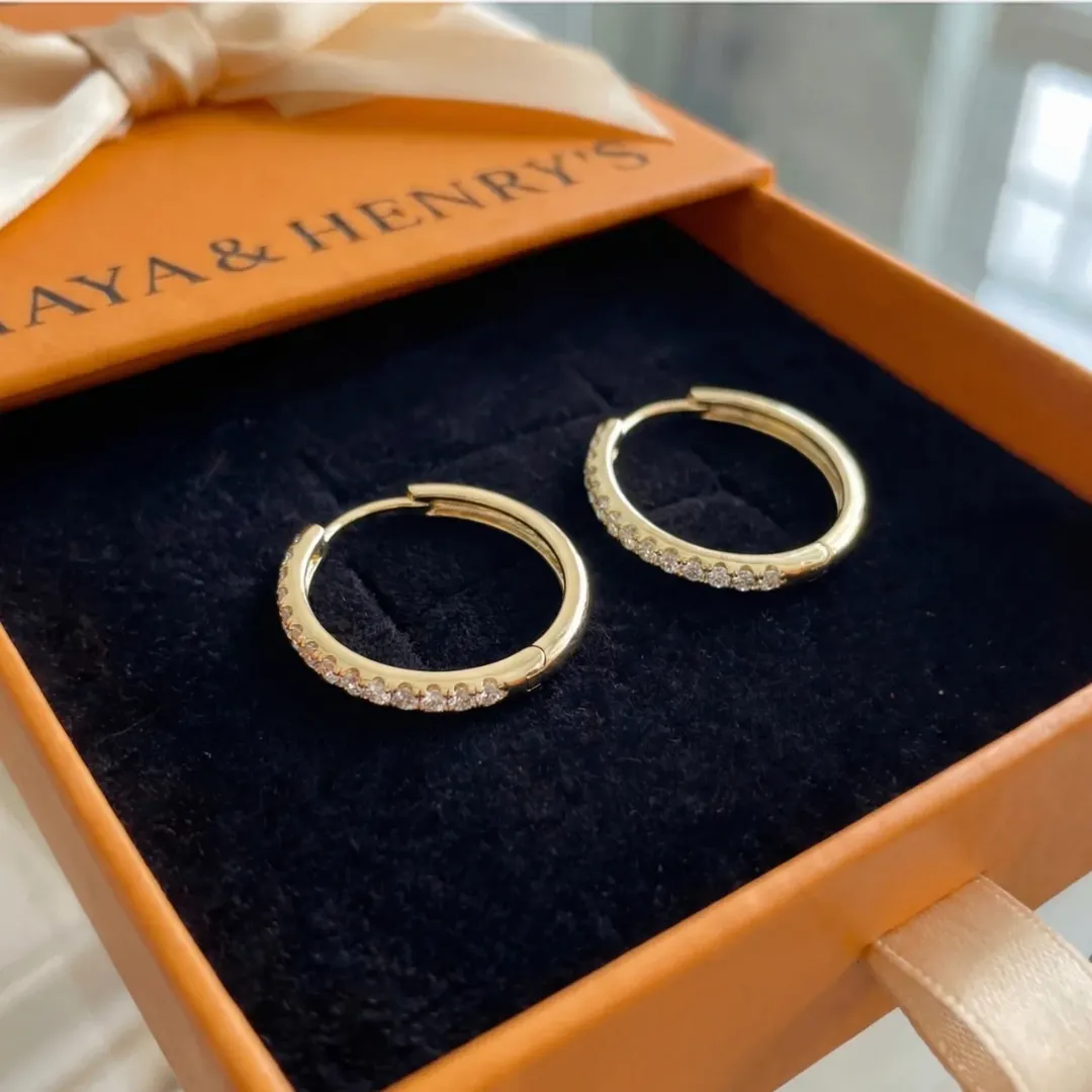 Gold hoop earrings in a jewelry gift box