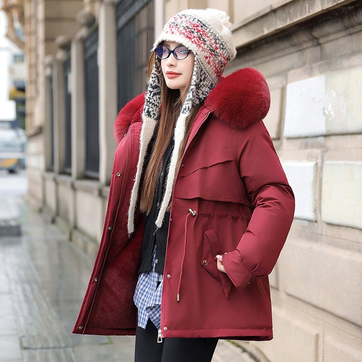 Woman in a parka with a drawstring waist at a cold weather tailgate