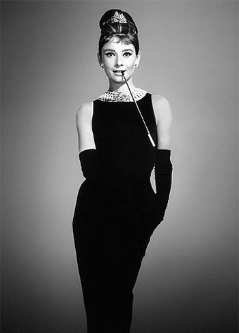 Woman in Audrey Hepburn Breakfast at Tiffanys black dress costume