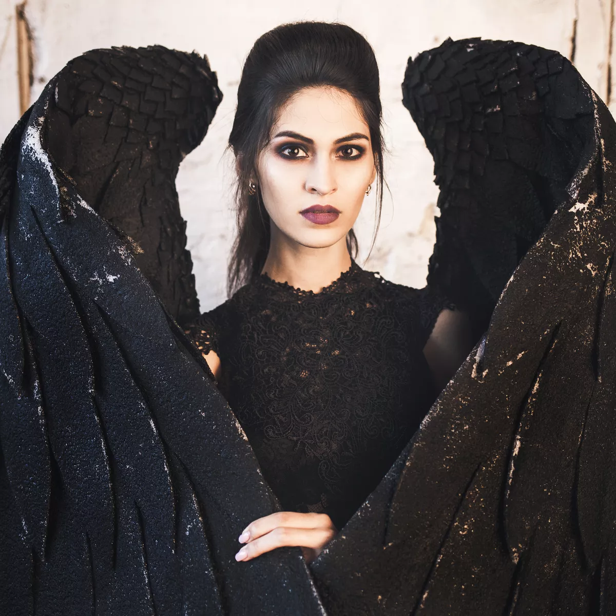 Woman in dark angel costume with black wings halloween