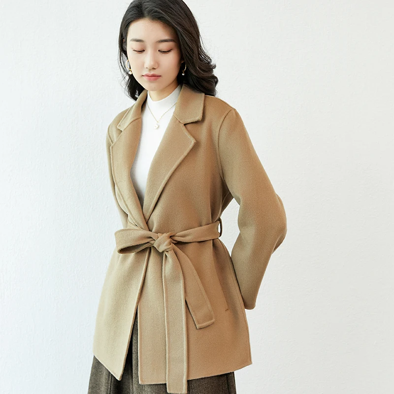 Woman wearing an elegant camel wool wrap coat