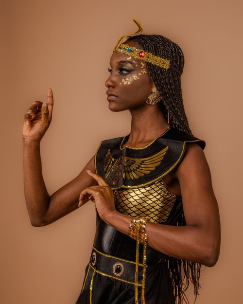 Black woman in a golden Egyptian goddess Halloween costume