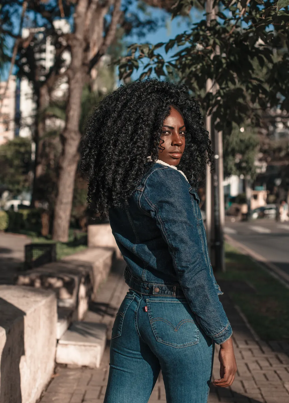 Black woman in a 00s R&B star Halloween costume with denim