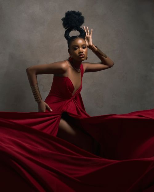 Black woman dressed as the Red Queen Halloween costume with crown