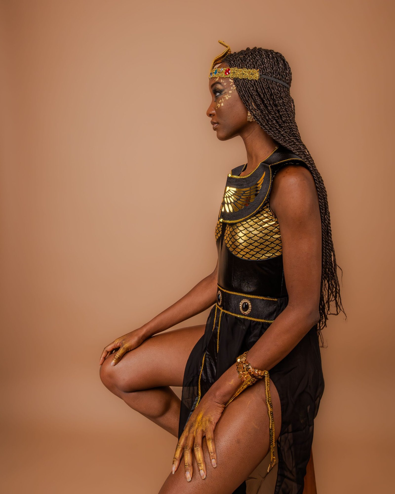 Black woman dressed as a warrior queen Halloween costume with braids