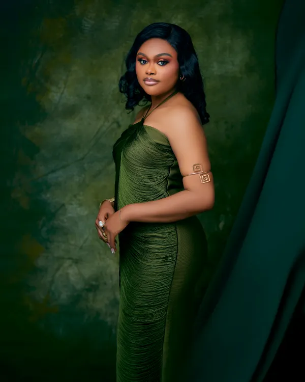 Black woman in a Princess Tiana Halloween costume with green gown
