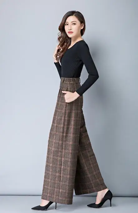 Woman wearing plaid wide-leg trousers with a fitted black top