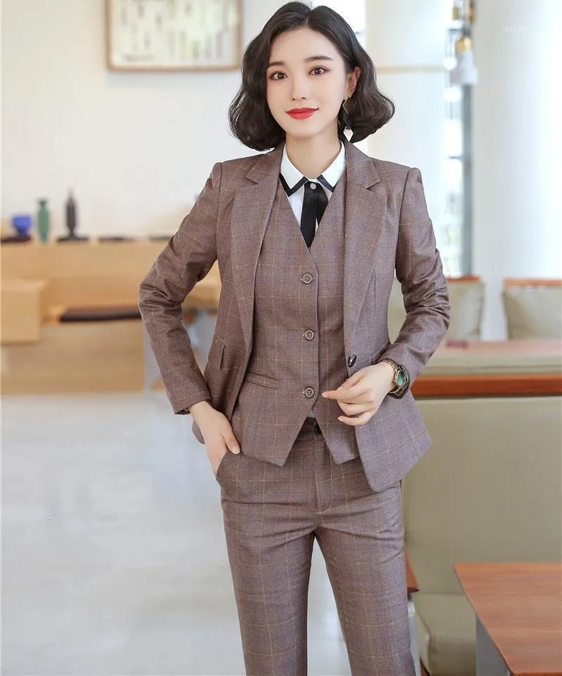 Woman wearing a matching plaid blazer and trouser suit