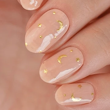 Gold crescent moon nail art on black nails minimalist