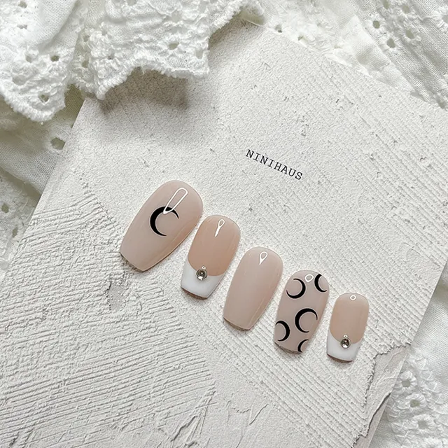Tiny moon phase nail art on nude nails minimalist