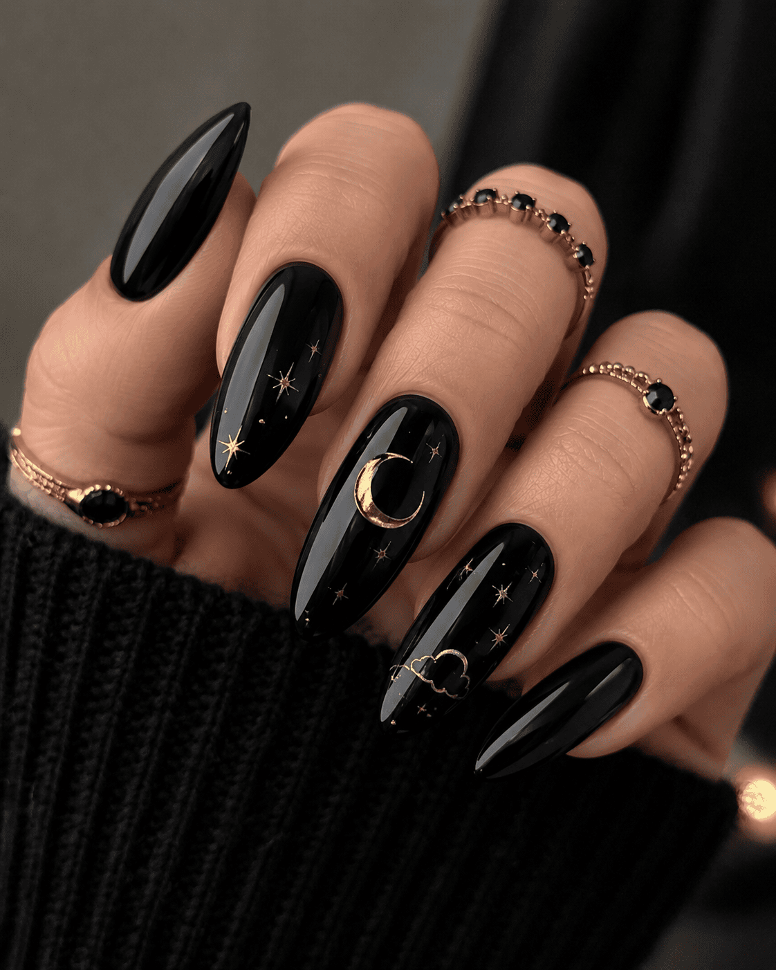 Gold foil crescent moon nail art on navy nails