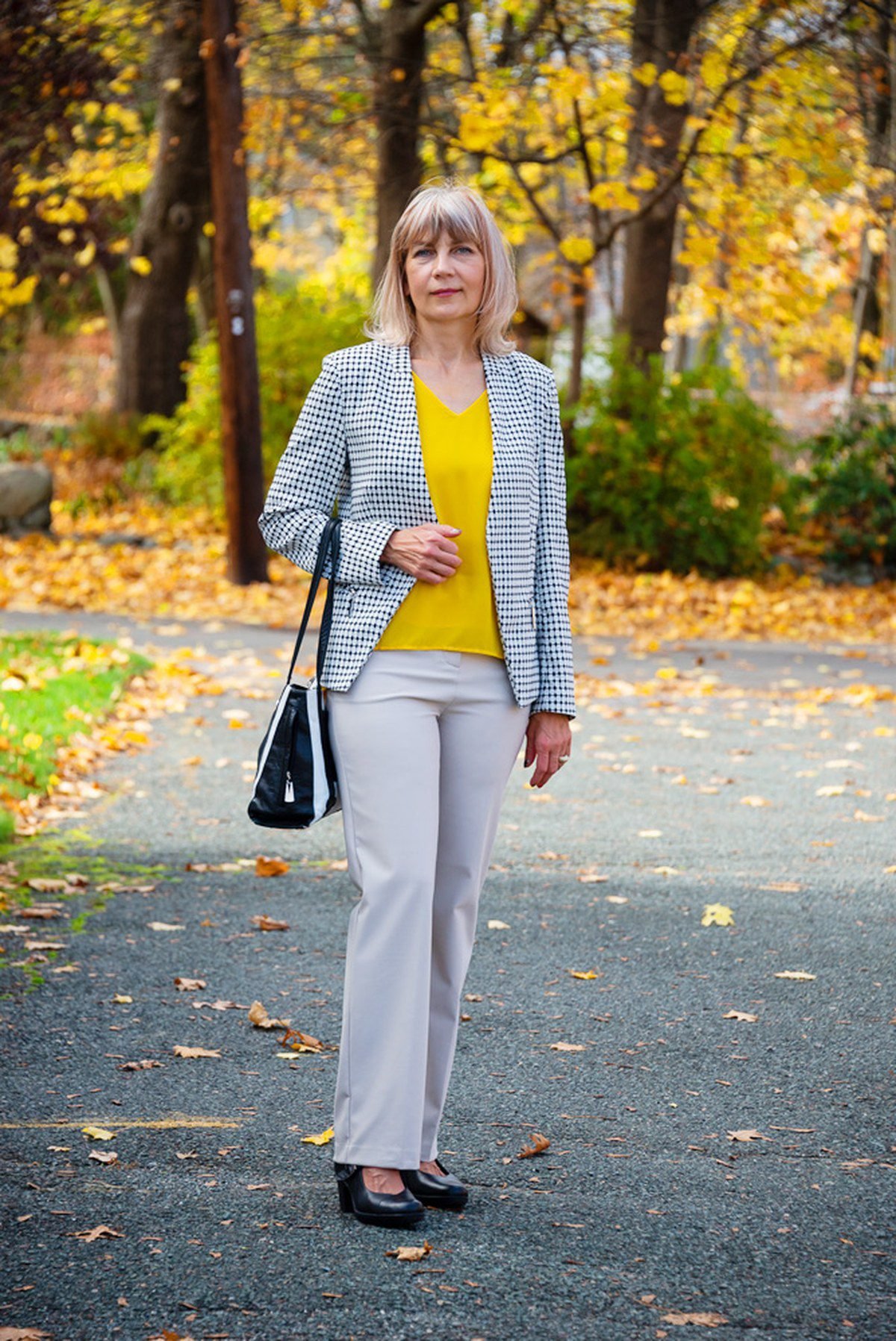 Woman wearing a long grey cardigan over a camisole with a black pencil skirt