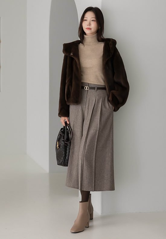 Woman in faux fur coat with midi skirt and turtleneck
