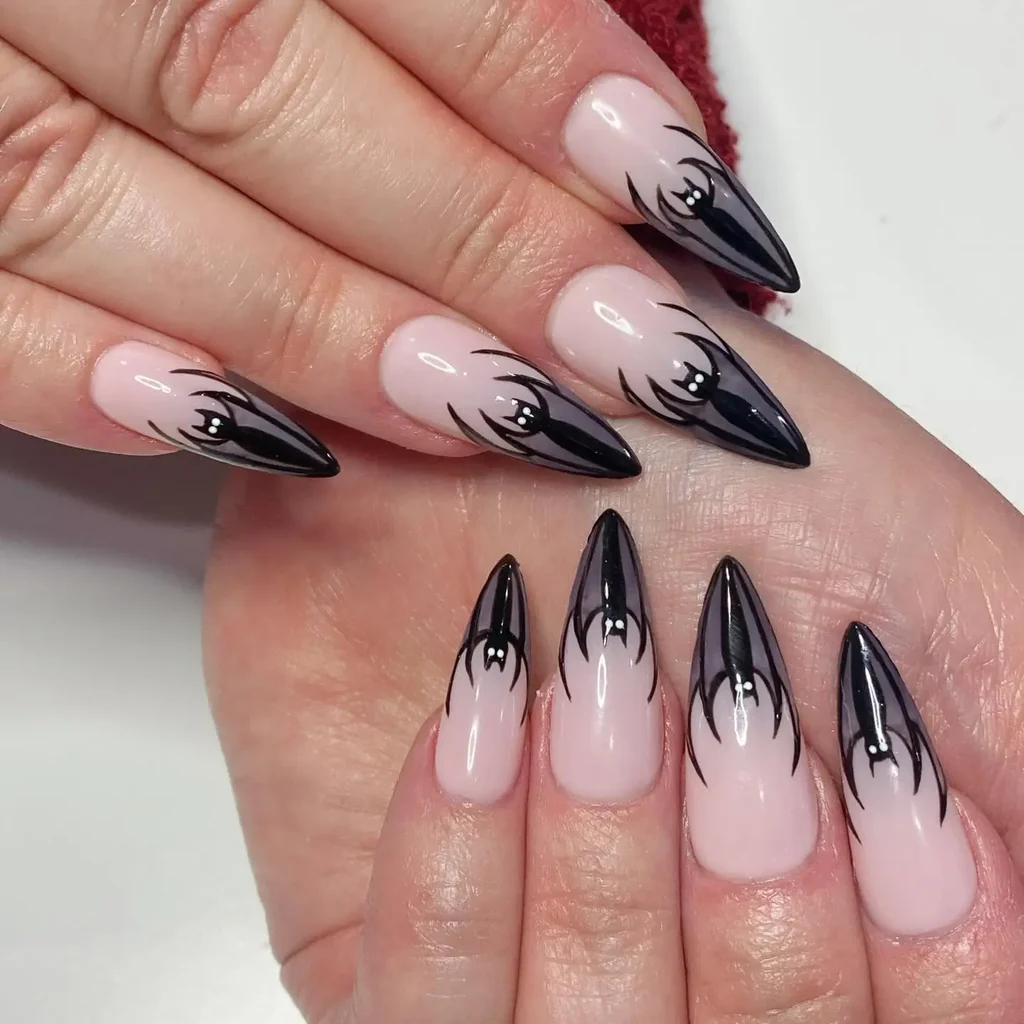 Elegant black bat silhouette nail art on gray nails