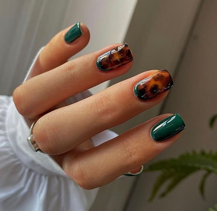 Deep teal square nails with a tortoise shell accent nail