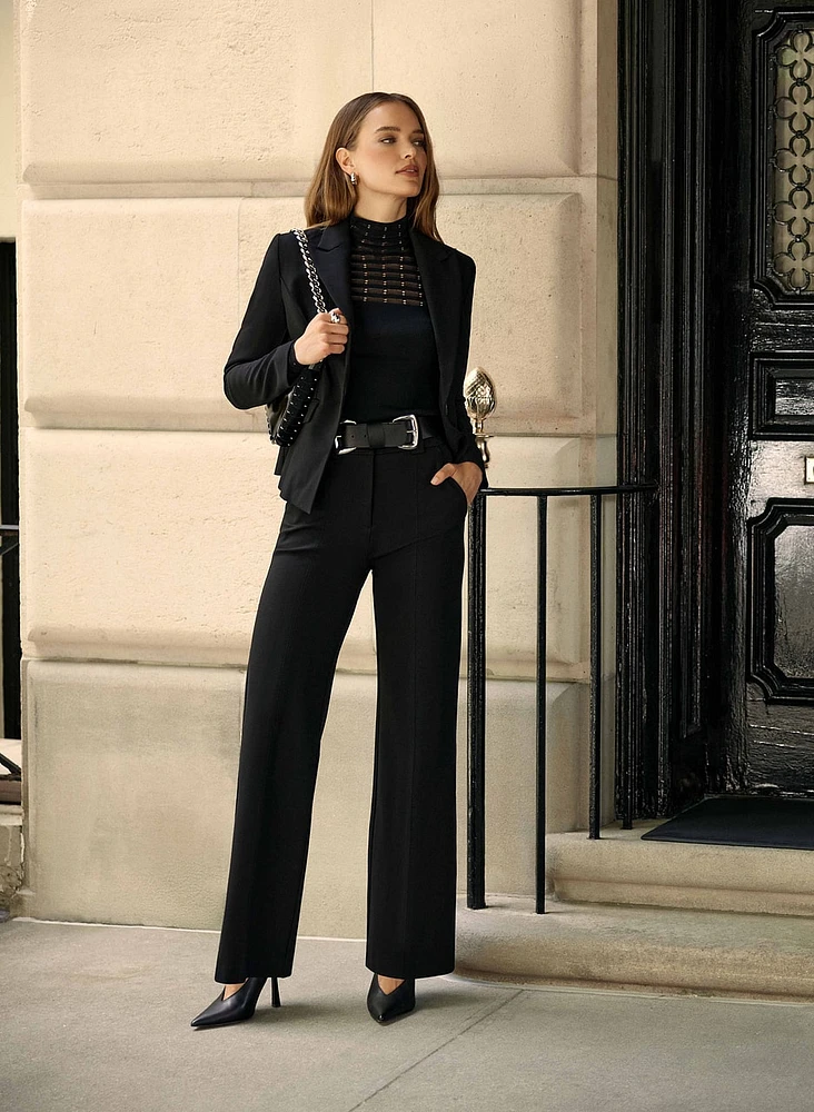 Woman wearing black tailored trousers
