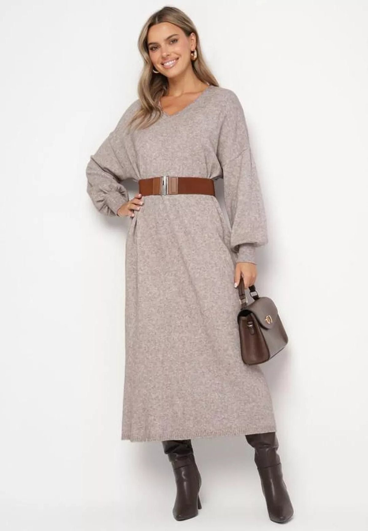Woman in a belted knit midi dress with tall boots