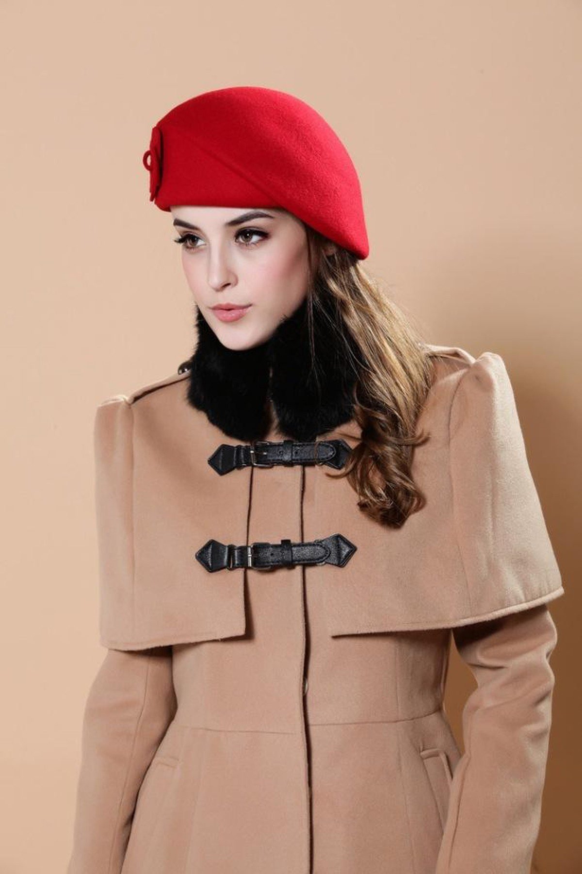 Woman wearing a red beret and camel coat in winter