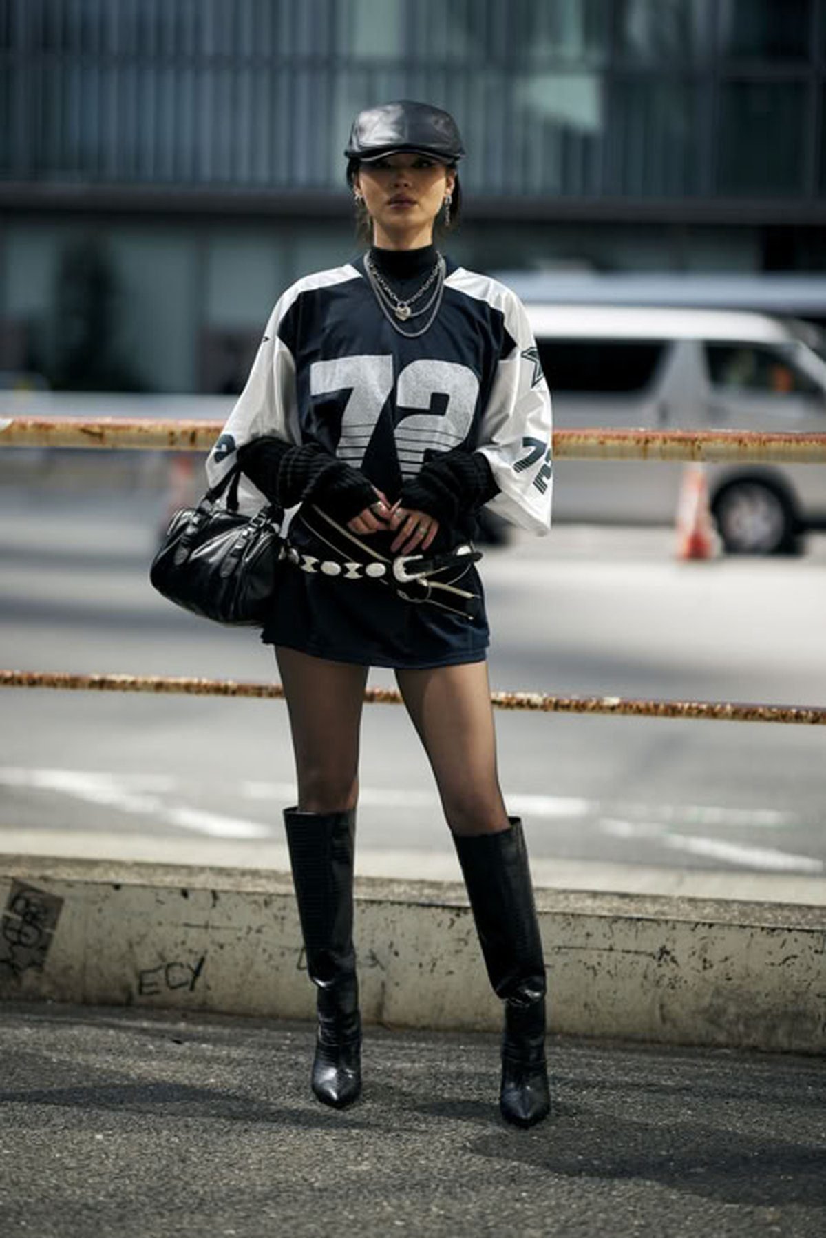 Woman layering an oversized jersey over a turtleneck for cold weather