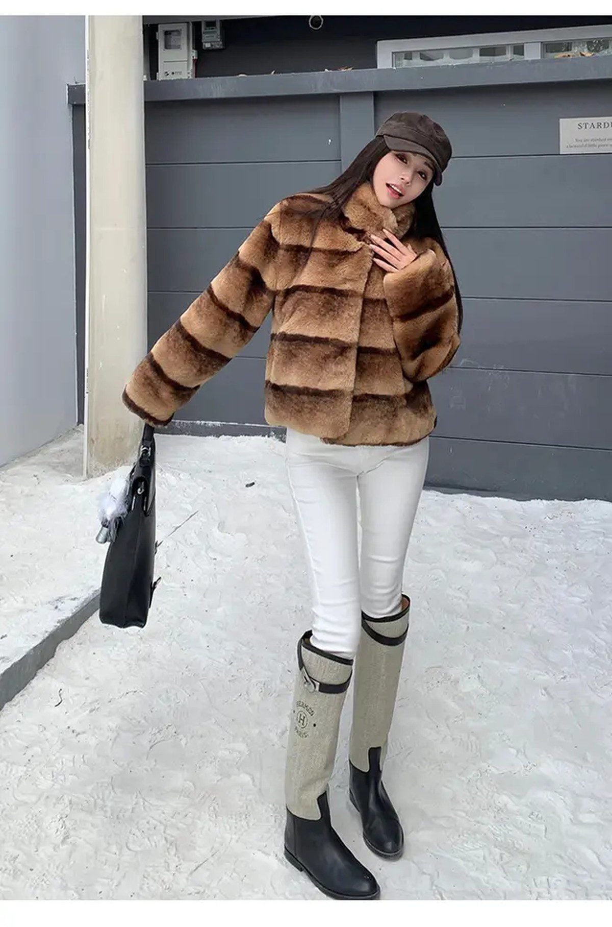 Woman in a faux fur coat with knee high boots in winter