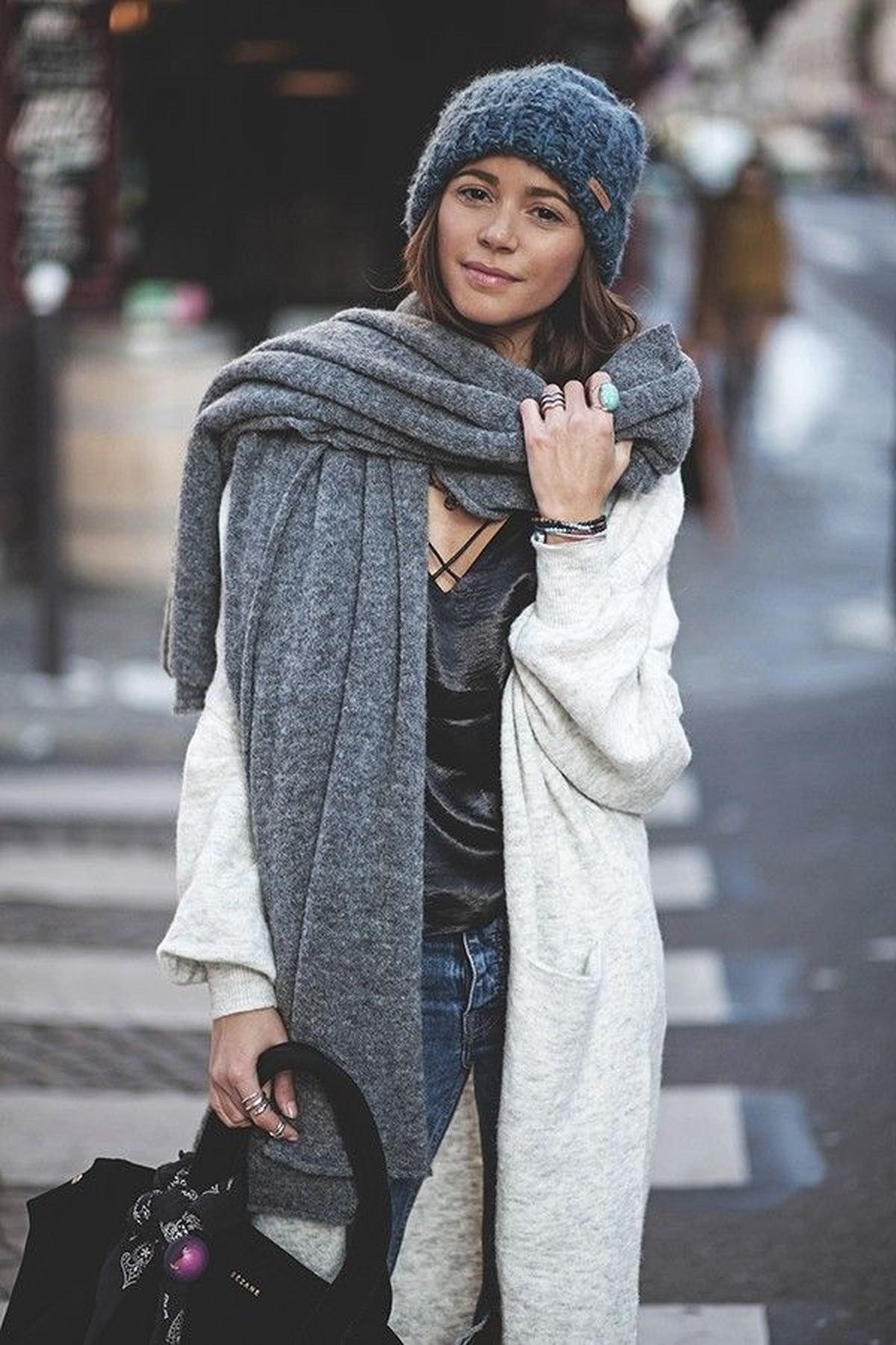 Woman in an oversized scarf and jeans, winter street style