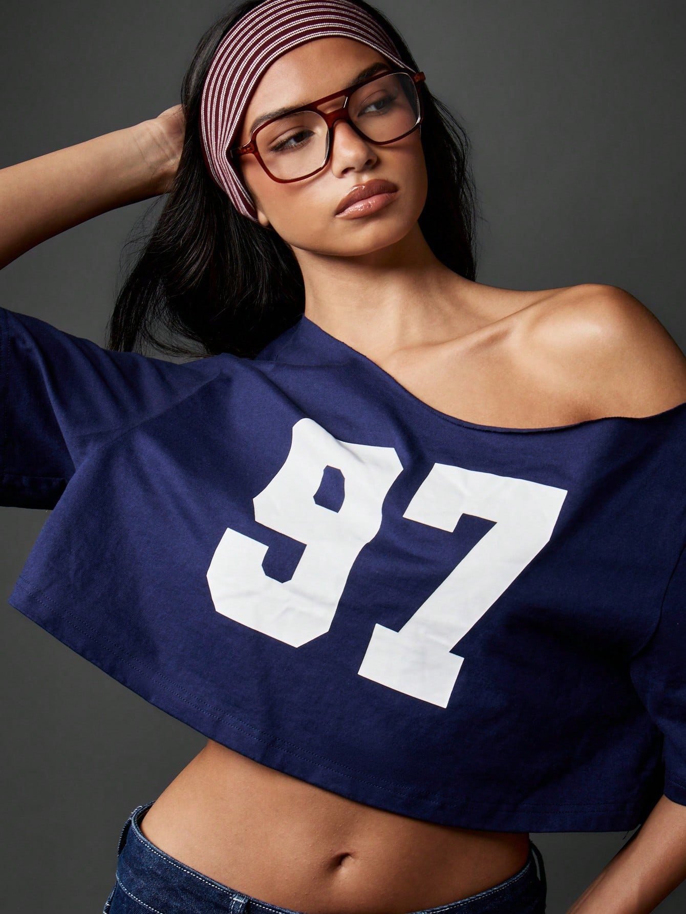 Woman wearing an oversized jersey off one shoulder