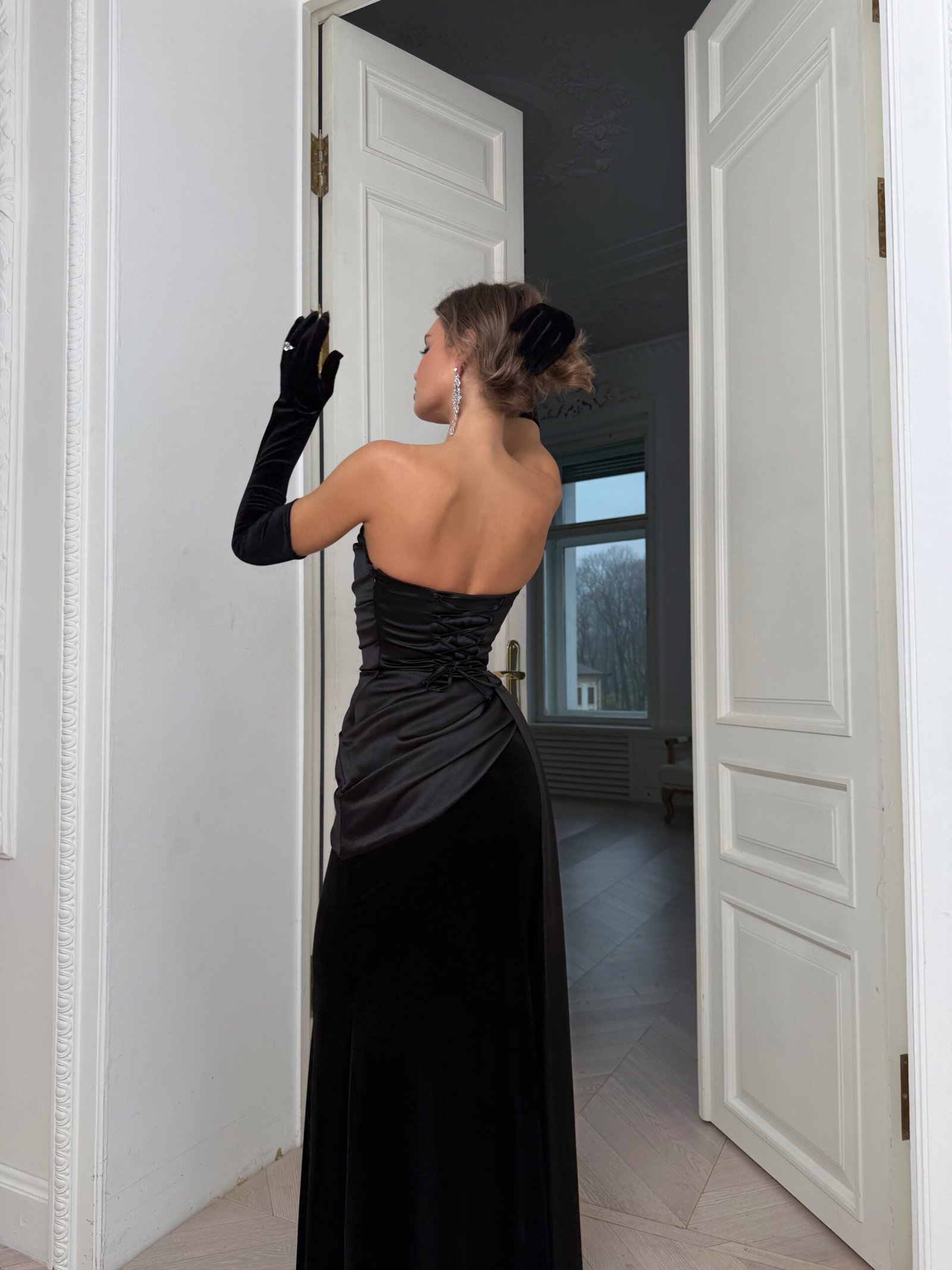 Woman in an elegant black dress for a winter opera night