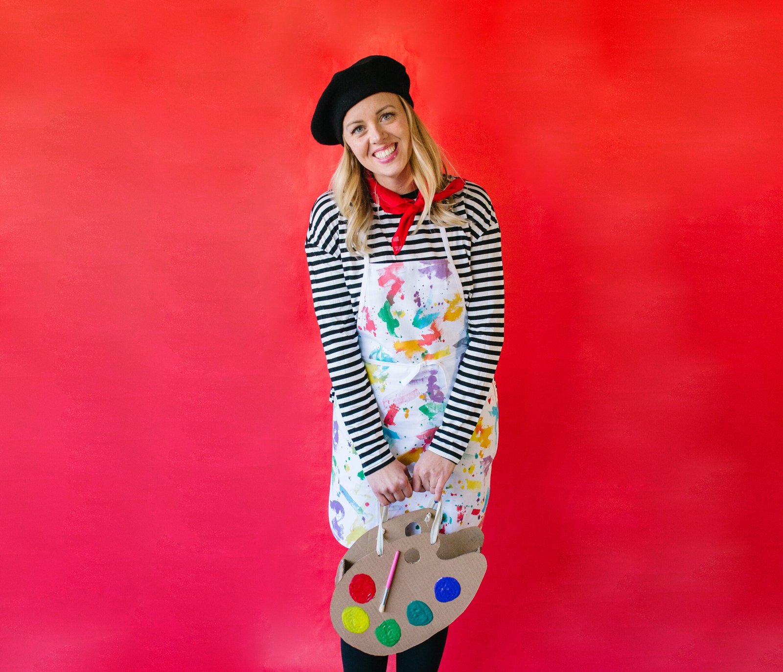 Woman in artist painter costume with jeans beret and paint splatter
