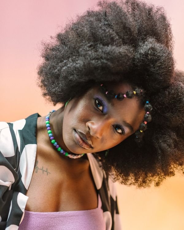 Woman in a colorful That's So Raven 00s Halloween costume