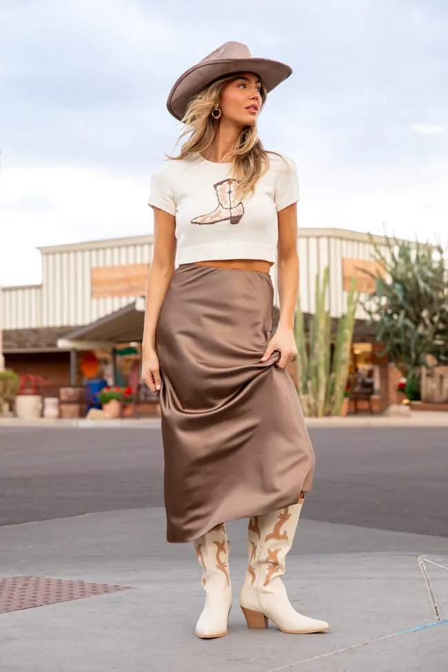 Woman in slip skirt with cowboy boots