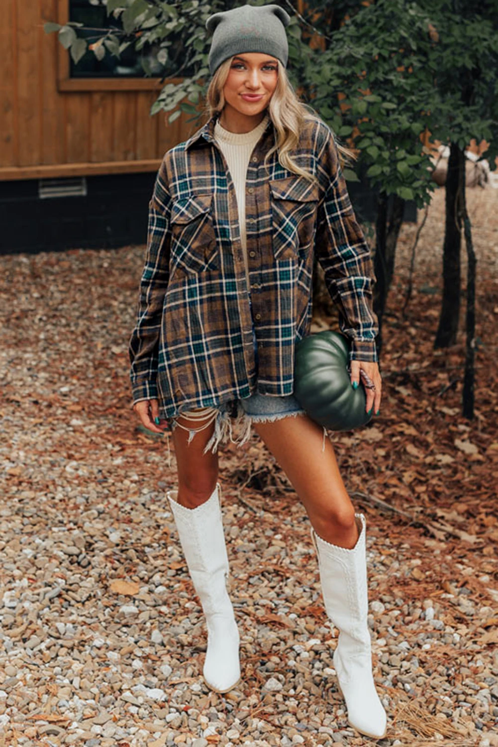 Woman in plaid shirt dress with cowboy boots