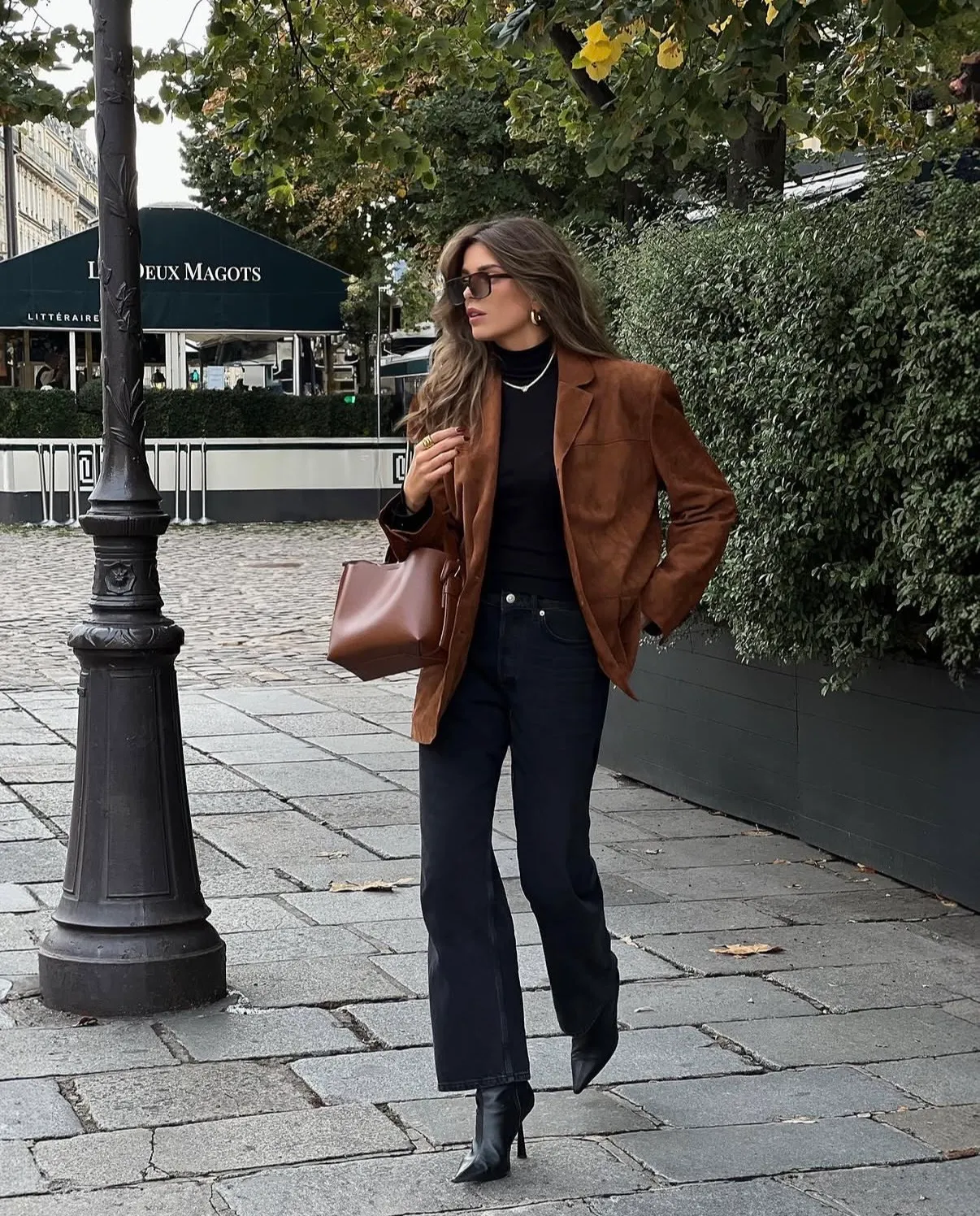 Woman wearing a turtleneck bodysuit with flare jeans and a blazer, polished fall outfit