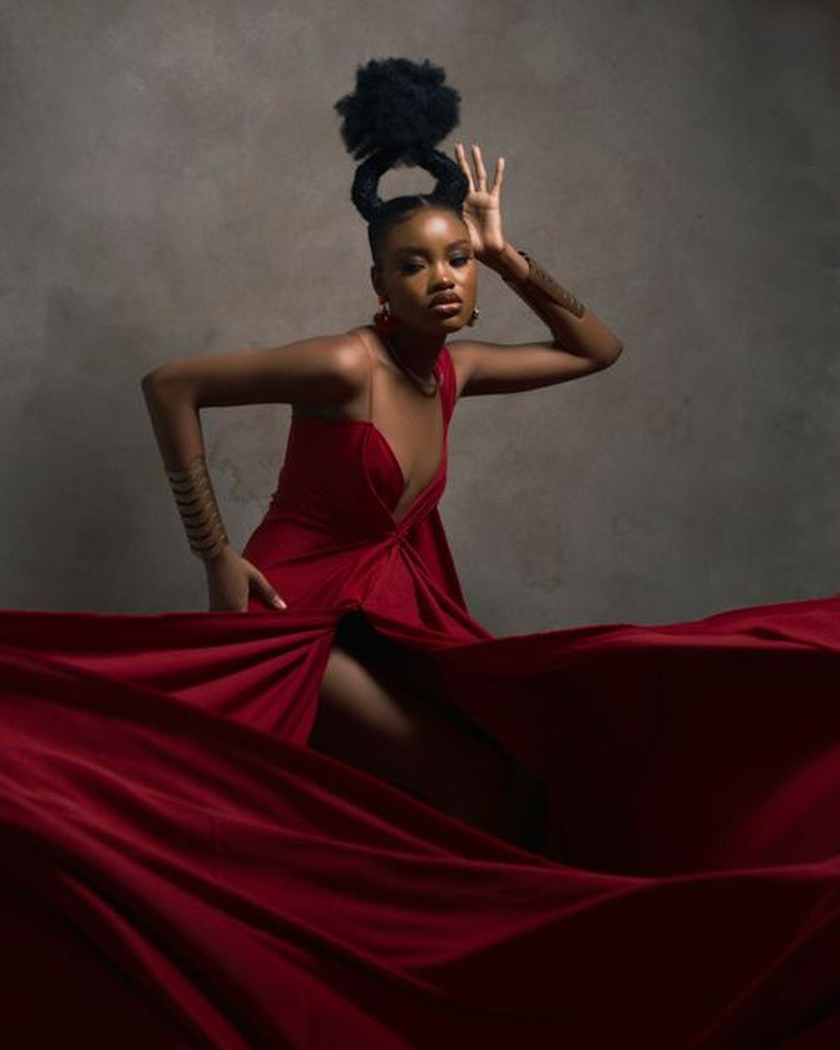 Woman wearing a backless evening gown with an elegant draped shawl wrap