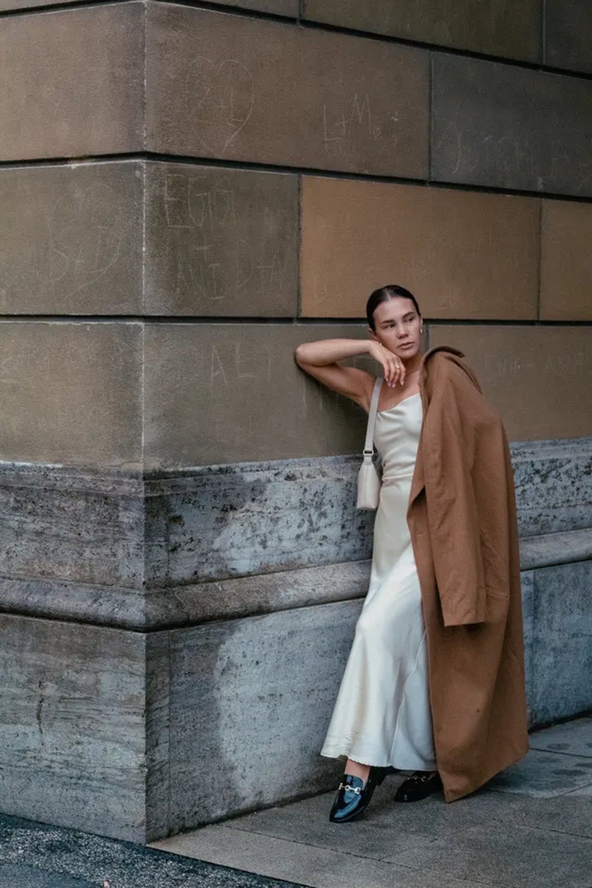 Woman wearing an embellished evening gown styled with polished leather loafers