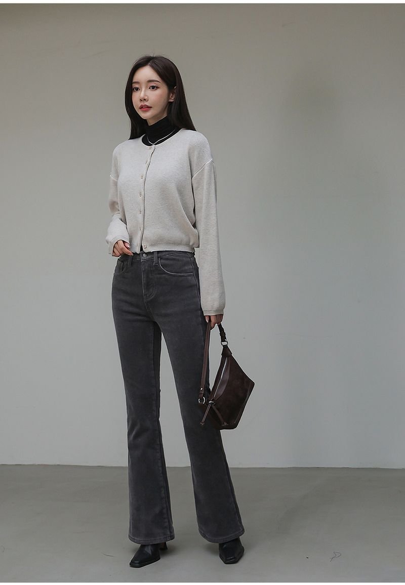 Woman in flare jeans with a cropped cardigan
